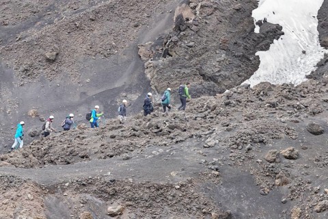 Group of hikers walking up to Mount Etna summit, Etna, Sicily, Italy, Europe