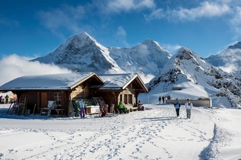 Wooden chalet and ski slope, with views of the Eiger, Mönch and Tschuggen, Grindelwald, Bernese