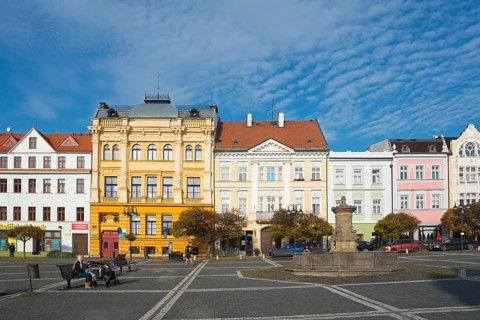 Urban street with historic buildings and a fountain under a clear sky, Ceská Lípa, Bohemian Leipa,