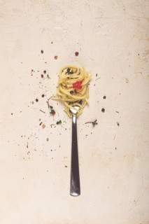 Spaghetti strung on a fork, on the table, dish concept, dish background, top view
