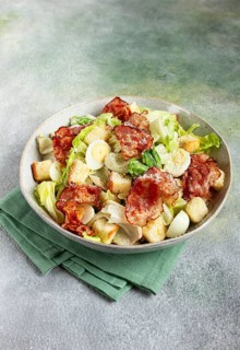 Caesar salad with fried bacon, quail eggs, homemade, no people
