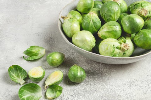 Fresh Brussels sprouts, raw, top view, on a gray table, no people
