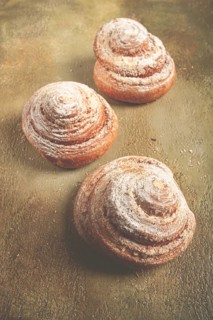 Bakery product, lemon twist, with white glaze, sweet bun, muffin, pastries, top view, no people