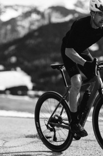 Road bike rider in spring in the Allgäu against the picturesque backdrop of the Alps, Bavaria,