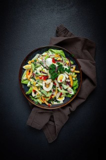 Salad with squid, fresh cucumber, eggs, sweet pepper, red onion, with dressing, homemade, no people