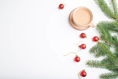 Christmas or New Year composition. Decorations, red balls, fir and spruce branches, cup of coffee,
