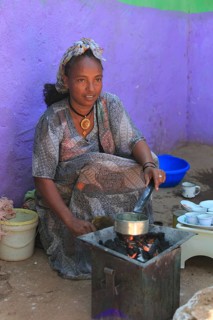 In the highlands of Abyssinia, in the village of Sina, young woman roasting coffee for the coffee