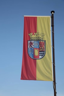 Flag and flagpole with coat of arms at Oberstein Castle, Idar-Oberstein, Hunsrück,