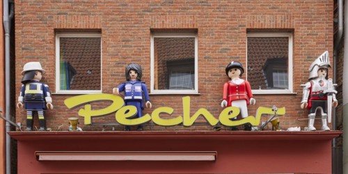 Oversized Playmobil figures for decoration on the façade of a toy shop in Warendorf, Warendorf