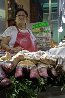 Oaxaca, Mexico, A vendor sells bull's feet and other meats at the Benito Juarez Market. Opened in