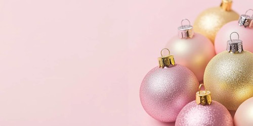 Christmas banner with pink and yellow bauble ornaments on pink background with copy space.