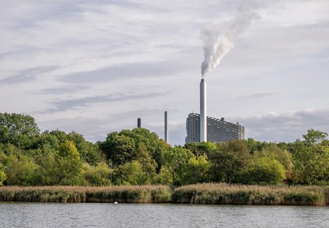 CopenHill or Amager Bakke waste incineration plant with ski slope and T-bar lift on the roof,