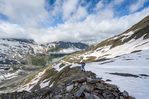 Mountaineer on hiking trail with snow, mountain landscape with summit Hoher Weißzint and