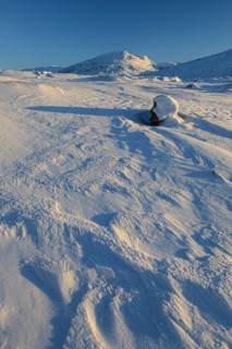 Snowy mountain landscape, evening light, sunny, snow drifts, wind, Björnfjell, Norway, Europe