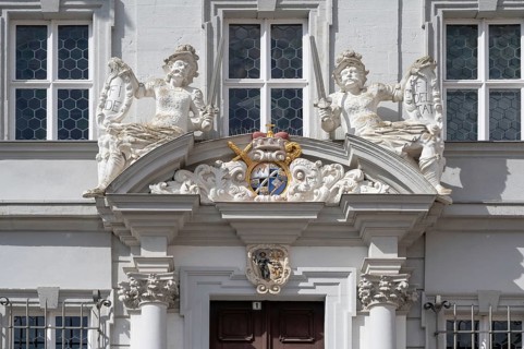 Entrance potal with sculptures and coat of arms of the baroque town hall, built in 1718, Iphofen,