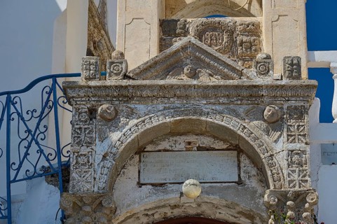 Detailed view of an old stone architecture with engraved decorations and an inscription, Platia and