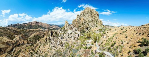 Panorama of Mountains and Olive groves around Ghost Town from a drone, Pentedattilo Village,