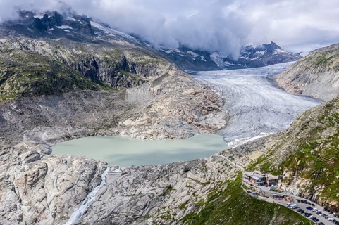 Drone shot of melting Rhone glacier, glacial lake, origin of Rhone river, Switzerland, Europe