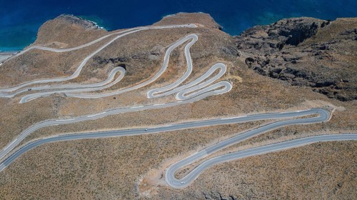 Aerial view of pass road serpentines from to Passo Anopoli above south coast of Crete at top of