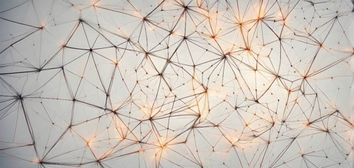 Abstract polygons shifting and rotating seamlessly, connected by glowing lines representing AI