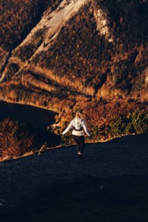 Trail running in autumn on the Jochberg on Lake Walchensee against the wonderful backdrop of the