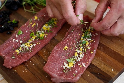 Swabian cuisine, preparation of lamb with prunes, raw lamb stuffed with herbs, rosemary, sliced
