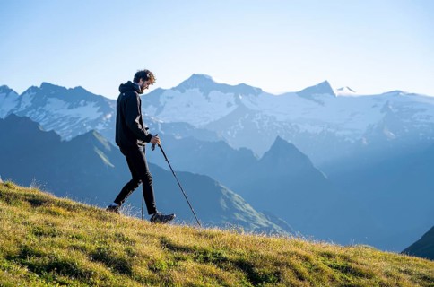 Hiker enjoying the mountain panorama in the morning, Venediger group, behind Dreiherrenkopf,