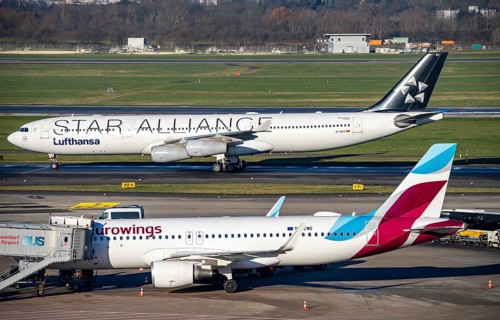 Lufthansa Airbus A340 on the way to take-off, Eurowings Airbus at the terminal, at Düsseldorf