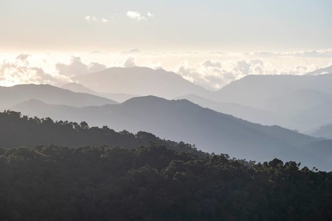 View of hills with cloud forest, in the evening light, Dramatic clouds between the mountains,
