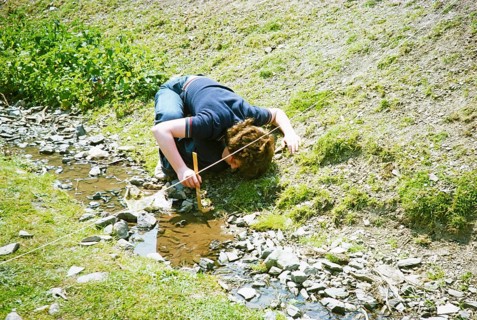 Secondary school student doing geographical fieldwork, Great Britain 1970s: Girl measuring the