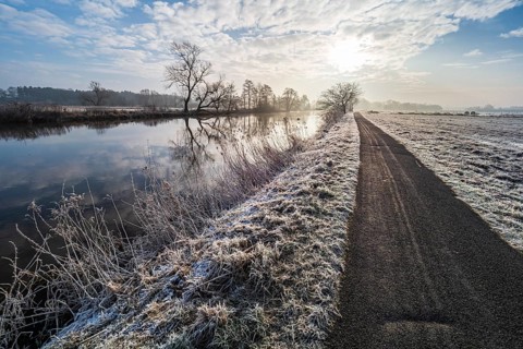 River Aller on a frozen winter day, hiking and cycling path along the river, between Celle and