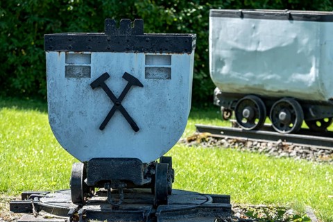 Trolleys for transporting brown coal underground, mining, mine wagon with hammer and iron symbol,