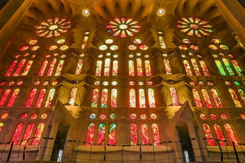 Colourful stained glass windows in the side aisle, Sagrada Familia, Basilica by Antoni Gaudi,