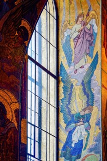 Window with frescoes and tiles in the Church of the Savior on Spilled Blood in the city of Saint