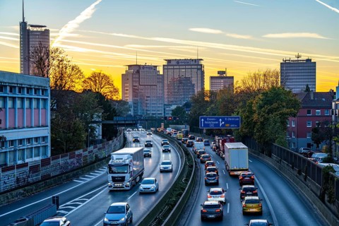 Evening traffic, partly with traffic jams, slow-moving traffic on the A40 motorway, skyline of