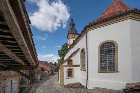 Former so-called Kirchgaden, barns, on the right the Protestant St John's Church in the historic