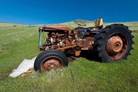 Old rusty tractor standing in a meadow, Mykines, Útoyggjar, Faroe Islands, Denmark, Europe