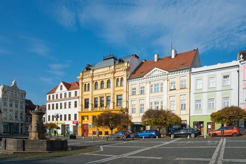 Colourful neoclassical townhouses line the square under a clear sky, fountain, Ceská Lípa, Bohemian