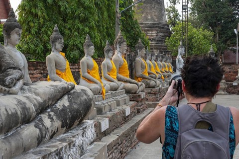 Tourist photographing the Buddha statues around the Great Chedi Chaya Mongkol, Wat Yai Chai