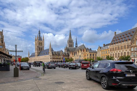 Cloth Hall with belfry and cars parked on the Grand Place at the city Ypres, Ieper, West Flanders,