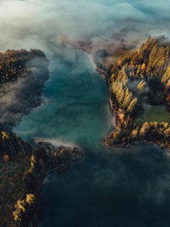 Autumn sunrise in the foothills of the Alps with fog at Illasbergsee and Forggensee near Halblech