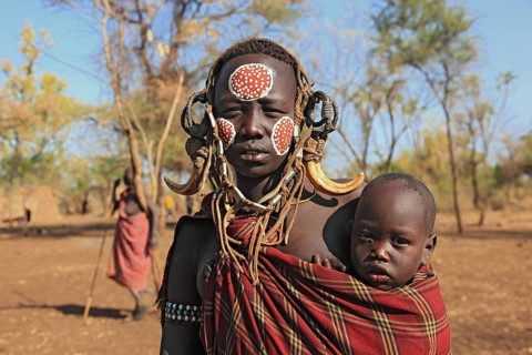 South Ethiopia, in Maco National Park, Mursi tribe, Mursi woman with baby, painted skin and