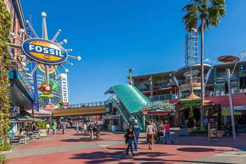 Shoppers and park guests walk through Universal's City Walk in Orlando, Florida, USA, North America