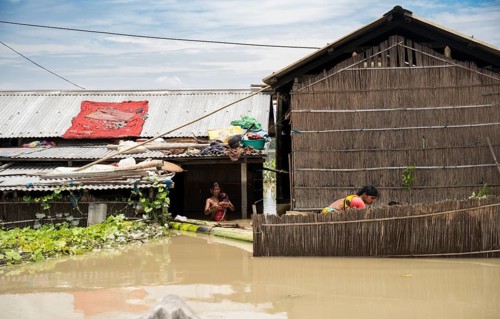 Morigaon, India. 4 July 2024. Residents in their flooded house, in a flood affected village in