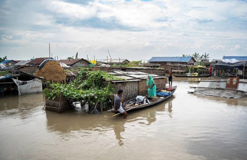 Morigaon, India. 4 July 2024. A settlement is partially submerged in flood in Morigaon district in