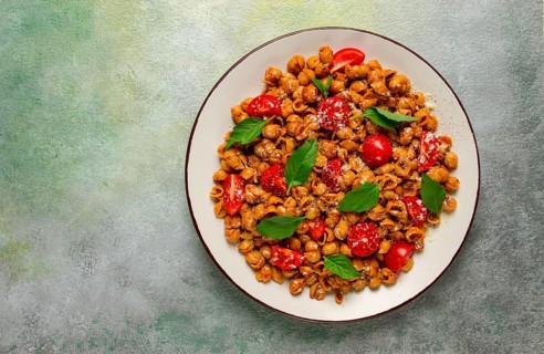 Tuscan pasta with smoked paprika and basil, parmesan cheese, Italian traditional cuisine