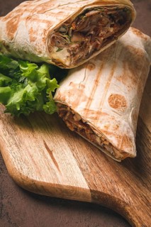 Cut shawarma, 2 pieces, on a cutting board, close-up