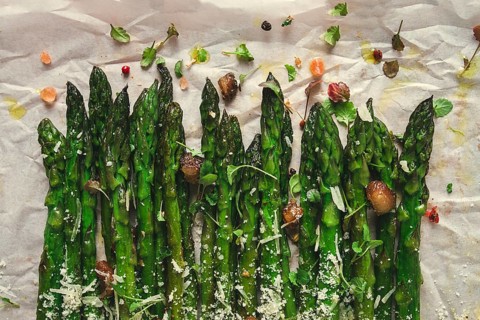 Grilled asparagus, with spices and herbs, parmesan cheese, on a white background, top view, rustic,