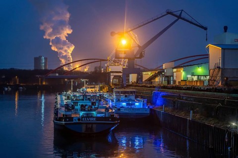Cargo ships and cranes in Essen city harbour, on the Rhine-Herne Canal, motorway bridge of the A42