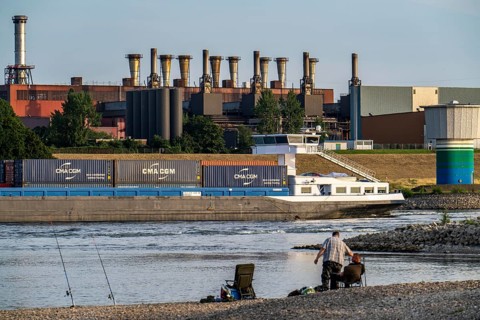 Industrial backdrop of the ThyssenKrupp Steel steelworks in Bruckhausen, on the Rhine, anglers in a